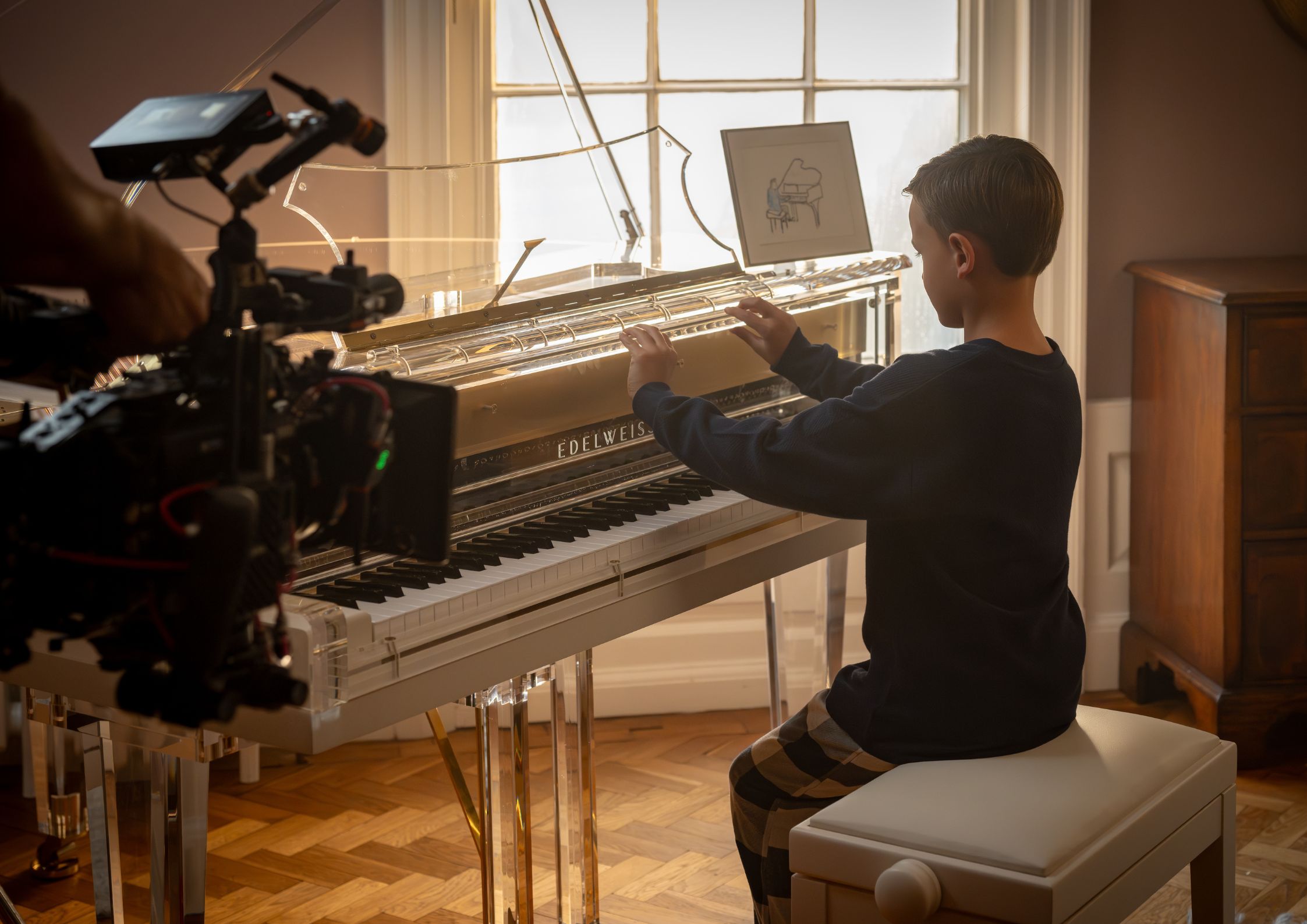 Actor playing piano on set of The Ultimate Gift by Edelweiss Pianos