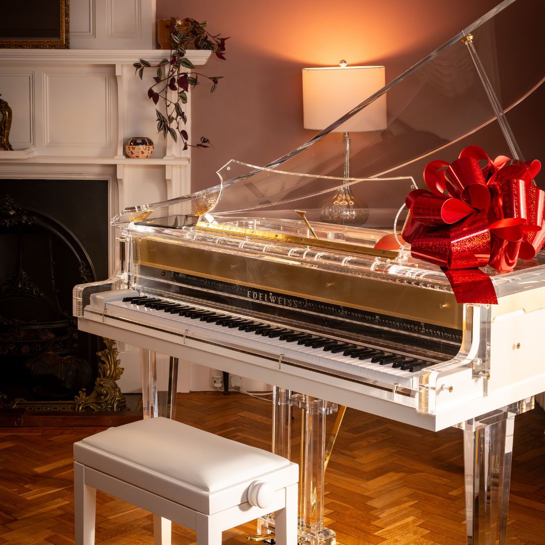 The Transparent S132 by Edelweiss Pianos with a gifting bow